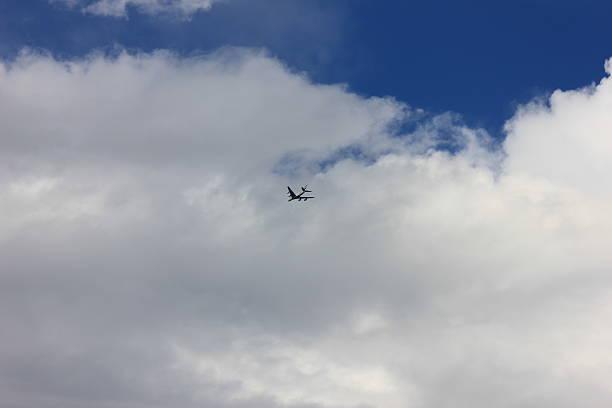 istock Airplane Flying Above the Clouds 2232114416