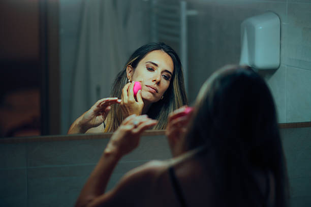 istock Woman Using a Blending Sponge to Apply Foundation in the Mirror 2232114586