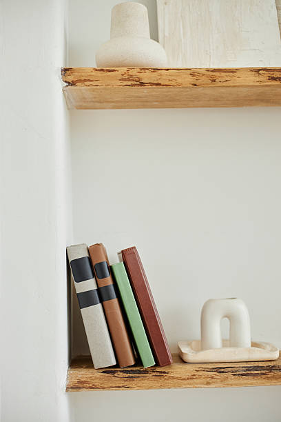 istock Stack of Books Arranged on Wooden Shelf in Minimalist Home Interior Setting 2232115892
