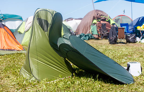 istock A green tent is sitting on the grass next to a green tent 2232118621