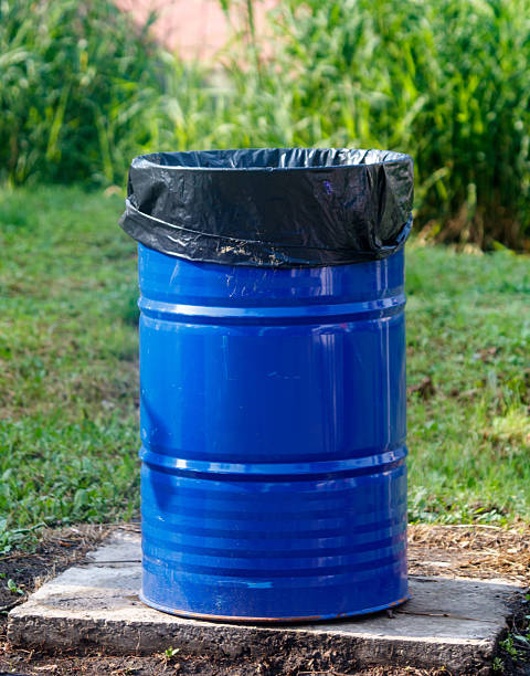 istock Blue trash can with a black plastic bag on top 2232118779