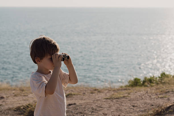 istock A boy goes for a walk along the seaside to study nature resources. 2232122351