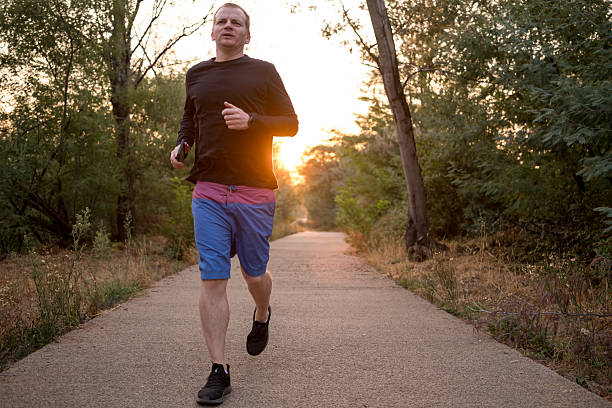 istock Man running in the park at sunset 2232126462