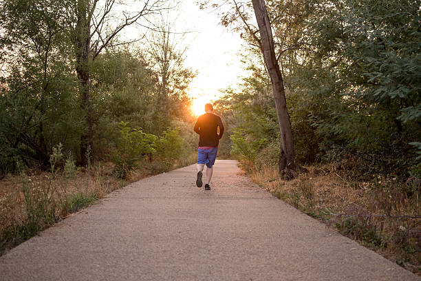 istock Man jogging at sunset in a park 2232126466