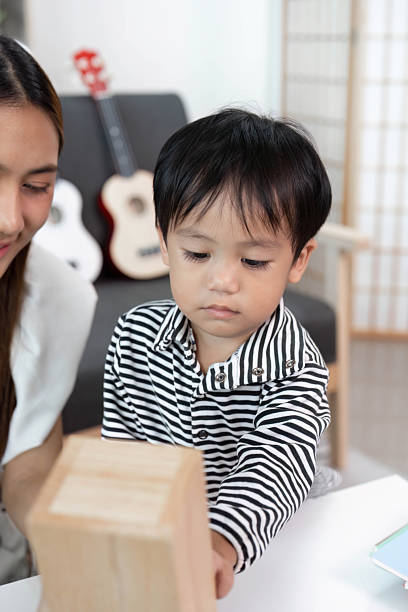 istock Child exploring creativity with mother in a playful setting 2232127085