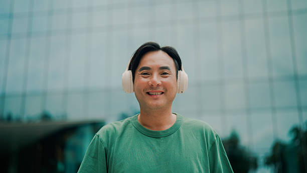 istock Mature Asian man wearing headphones while getting ready for his morning exercise. 2232130674