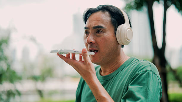 istock Middle-aged Asian man speaking to AI assistant before continuing his run in the public park. 2232130736