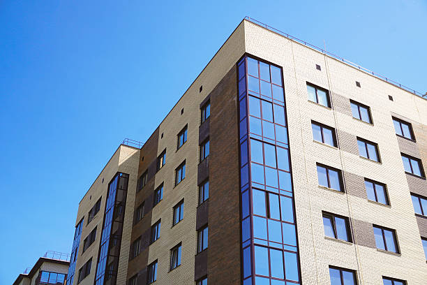 istock Modern apartment building reflecting blue sky on a sunny day 2232132443