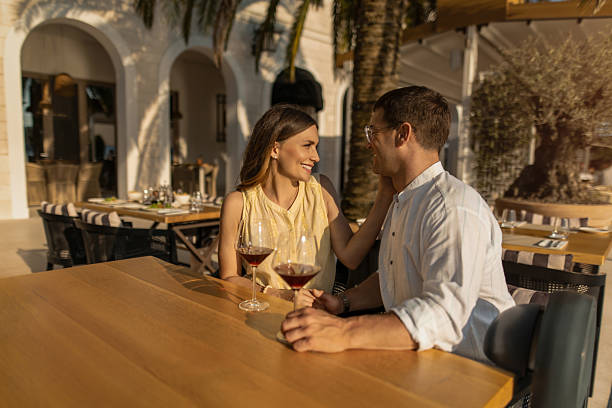 istock Couple sitting at waterfront cafe. 2232132982