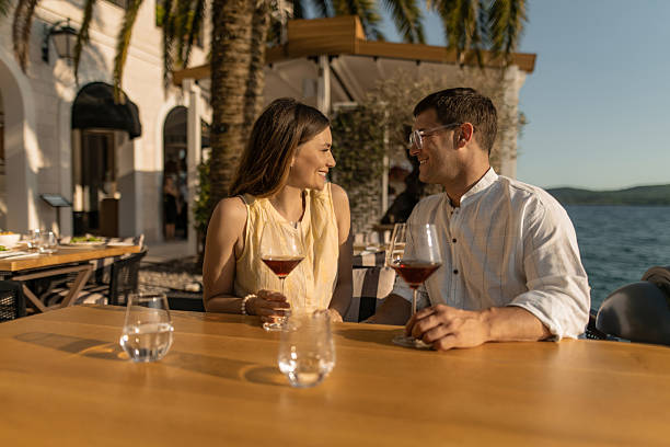 istock Couple sitting at waterfront cafe. 2232133109