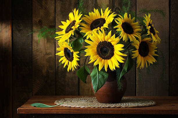 istock Sunflowers bouquet illuminating rustic wooden table 2232133152