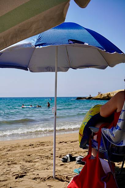 istock Beach umbrella on the blue sand 2232134760
