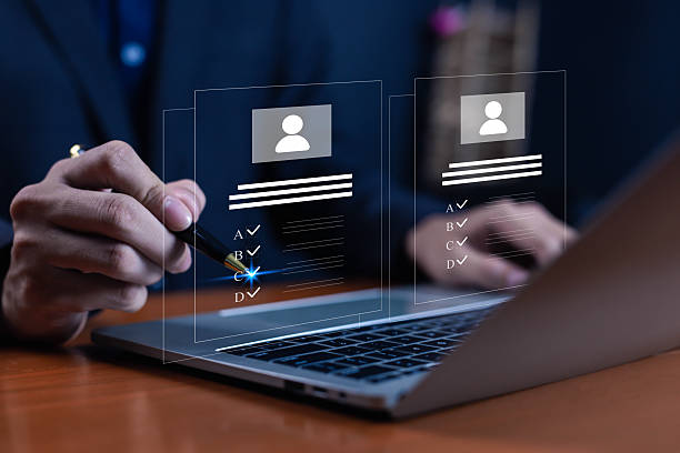 istock Businessman using laptop with digital interface of candidate profile and checklist for recruitment, online job application, employee selection, HR technology, hiring process and workforce management. 2232135461