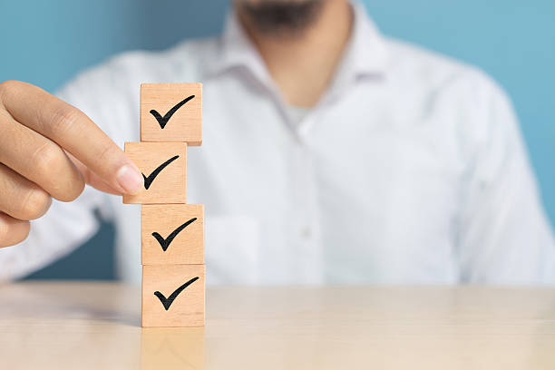 istock Wood cube with check mark on blue background, Checklist concept, Copy space. 2232136001