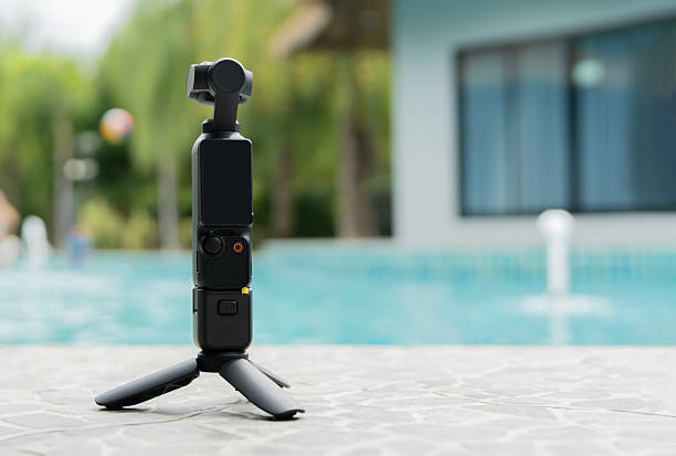 istock Action small camera and tripod setting on floor nearby a swimming pool background 2232138083