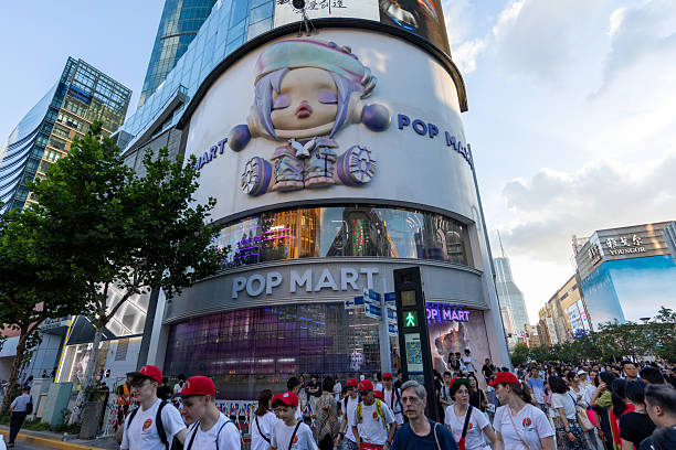 Shanghai, China - August 15, 2025 : Pedestrians walk past the Pop Mart store in Shanghai, China.