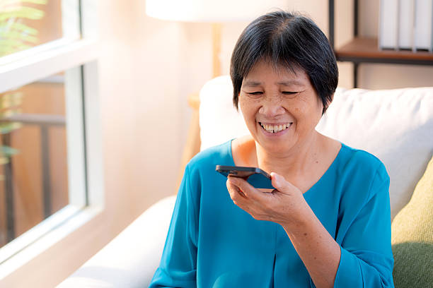 istock Senior asian woman speaking on smart phone with chatbot AI, technology artificial intelligence on smartphone with assistant and consult of elder woman, female using voice on phone. 2232141192