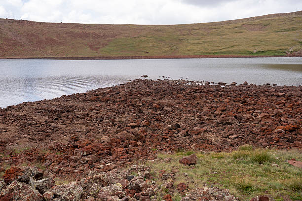 Alpine Volcanic Lake in Remote Crater under Dramatic Sky