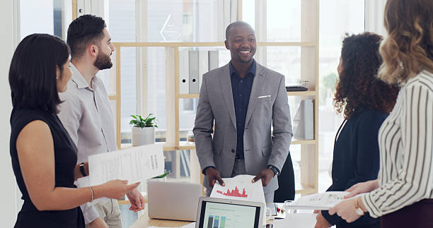 istock Meeting, group and team with documents, office or confident for project, financial analyst and data. Colleagues, collaboration and people with paperwork for investment opportunity, stats or corporate 2232146568