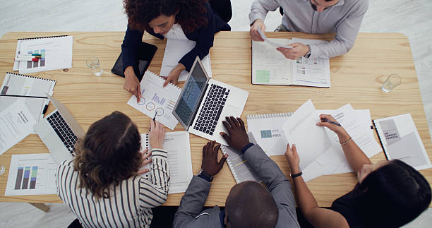 istock Business graph, people and group with paperwork for campaign planning, KPI performance and above. Chart, teamwork and laptop in office for brainstorming data, analytics report or marketing management 2232146651