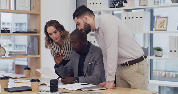 istock Meeting, group and discussion with documents, office and planning for project and financial analyst. Colleagues, collaboration or people with paperwork for investment opportunity, talk and corporate 2232146659