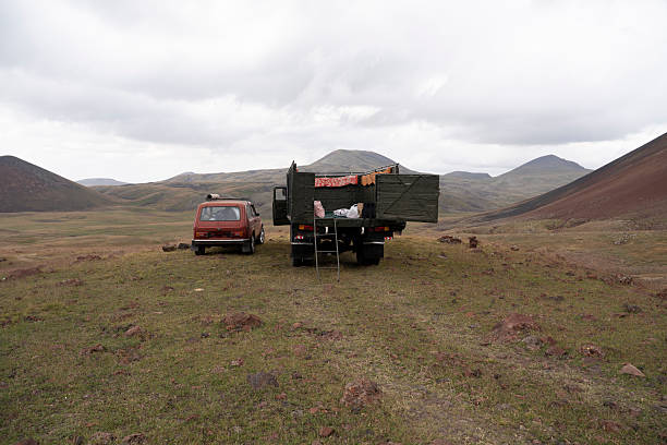 Vintage Vehicles Resting in Isolated Highland Landscape