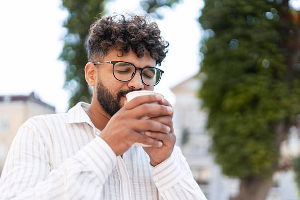 istock Young man enjoying a hot beverage outdoors 2232153319