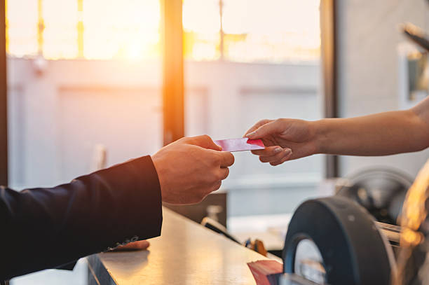 istock Close-up receptionist hand taking room key card during check-in process at the hotel counter. Business travelling guest receiving room access. 2232153392
