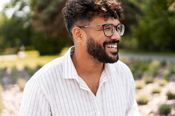 istock Young Indian Man Smiling in a Park 2232153571