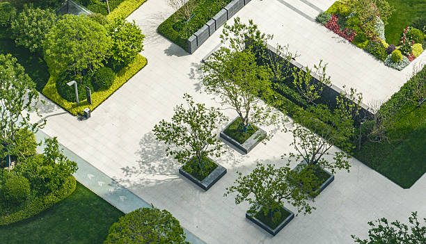 istock Organized green plaza with patterned walkways and young trees in residential complex. 2232154156