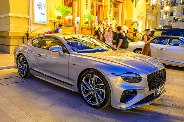 Bentley Continental GT coupe parked on the Casino square in Monte Carlo in Monaco during a summer evening.
