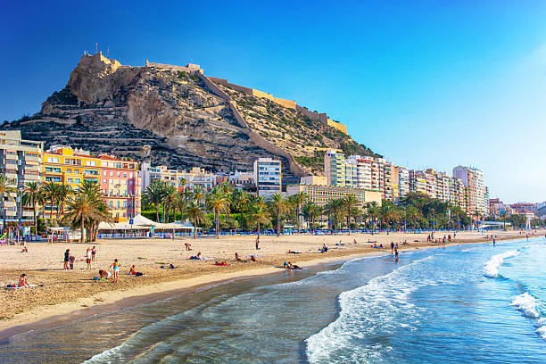 Postiguet beach with Santa Barbara Castle on background in Alicante, Spain
