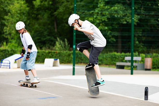 istock School age boy skateboarding and making ollie 2232155380
