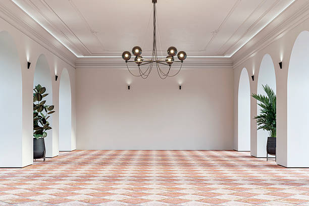 istock Modern empty interior with elegant arched openings, decorative ceiling molding, chandelier and decorative potted plants on diagonally tiled rustic ceramic floor 2232155519