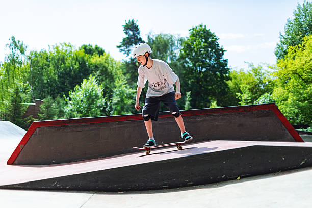 istock School age boy skateboarding in park 2232156026