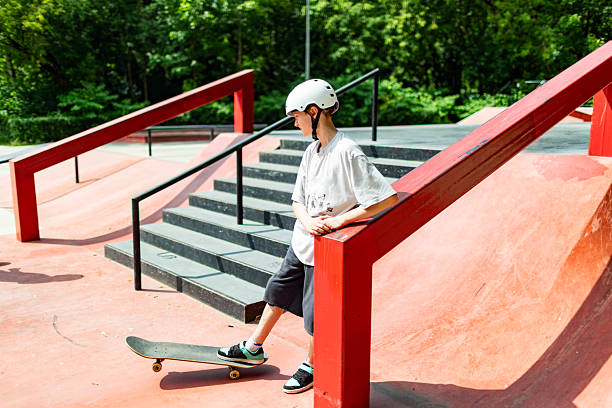 istock School age boy skateboarding in park 2232156027