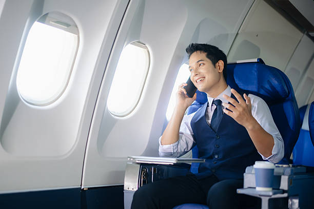 istock Confident businessman making a call in first class, enjoying comfort and connectivity during an international business trip. Ideal for travel, lifestyle, and corporate themes. 2232158646
