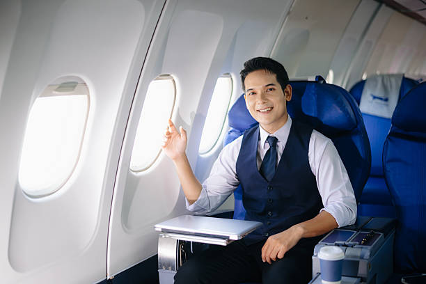 istock Confident businessman sitting in first class, smiling with a relaxed and professional look. Perfect for travel, lifestyle, and corporate success themes. 2232158688