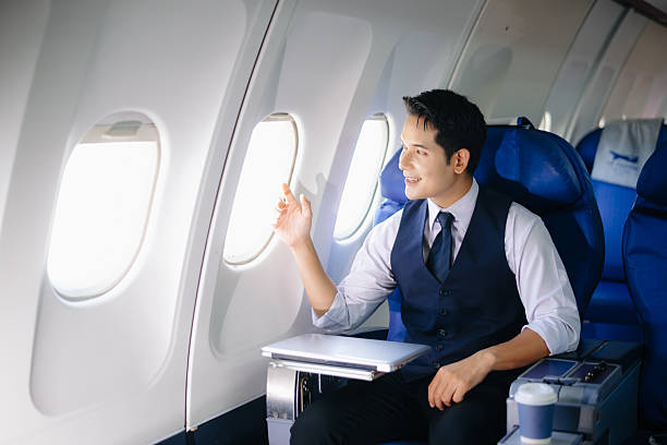 istock Confident businessman sitting in first class, smiling with a relaxed and professional look. Perfect for travel, lifestyle, and corporate success themes. 2232158691