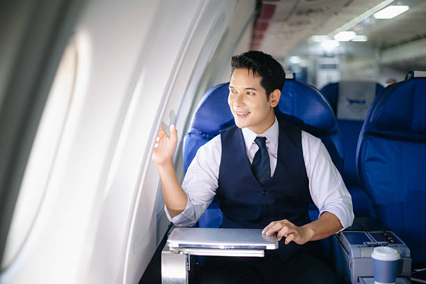 istock Confident businessman sitting in first class, smiling with a relaxed and professional look. Perfect for travel, lifestyle, and corporate success themes. 2232158708