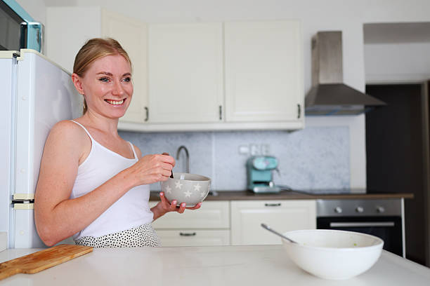istock Cheerful woman cooking in modern kitchen interior 2232162729