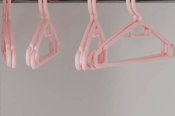 istock Plastic soft pink hangers for children's clothes in the wardrobe. 2232162790