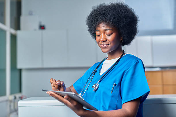 istock Smiling Medical Professional with Tablet in Reception Area 2232164406
