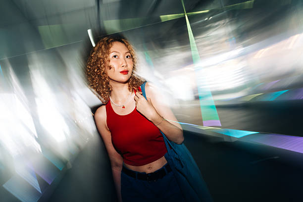 Young woman standing in artistic light swirl
