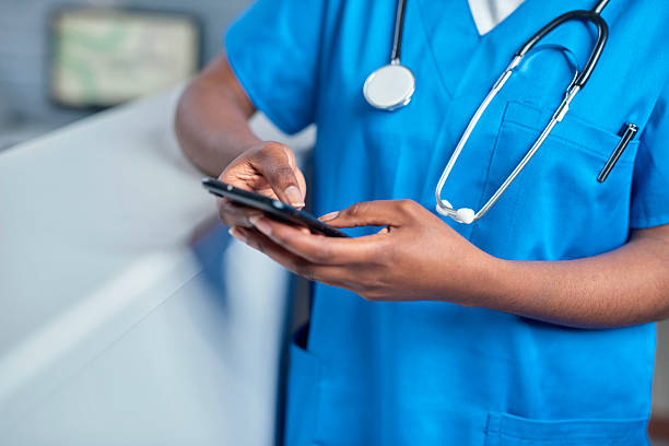 istock Medical Professional Using Mobile Device in Hospital Reception Area 2232164428