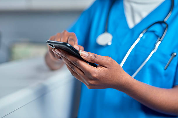 istock Medical Professional Checking a Phone in Reception Area 2232164429