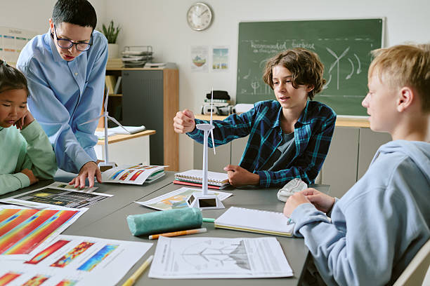 istock Teenage Students Collaborating on Science Project with Teacher in Classroom 2232164638