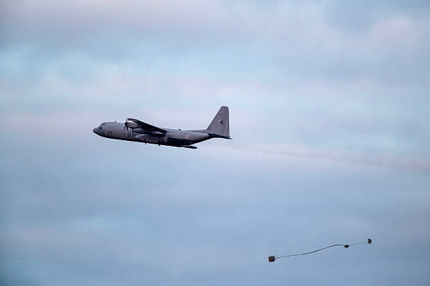 military aircraft hercules flying low in the sky training for a dropping