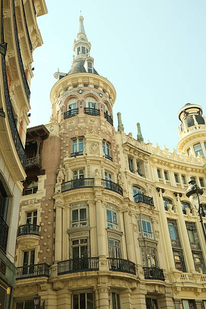 istock Elegant Cream-Colored Building with Tower Under Sunny Blue Sky 2232168673