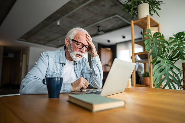 istock Senior man feeling tired and stressed while working at home 2232168827